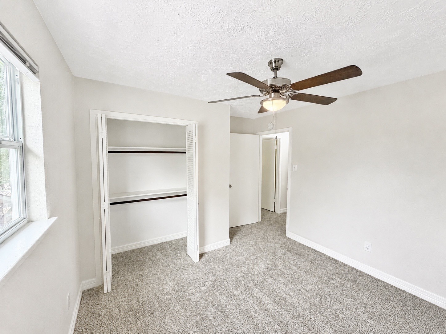 8407 Riverside Walk Lane Houston, TX 77064 - Photo 30 of 33 Additional secondary bedroom featuring new carpet, a ceiling fan, and a neutral color palette ready for your personal touch.