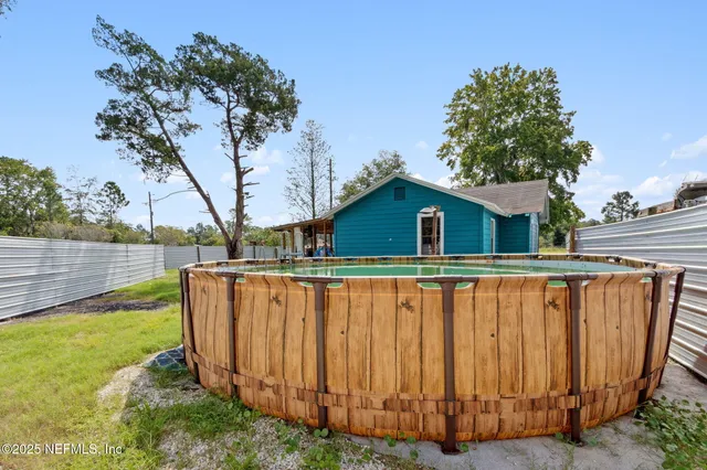 a view of a house with a yard and sitting area