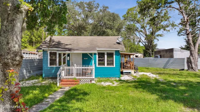 a front view of a house with a yard table and chairs