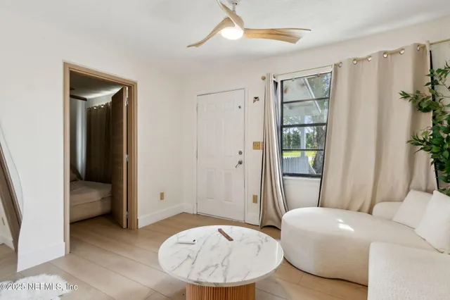a living room with furniture and a mirror