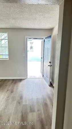 an entryway of a house with an empty room