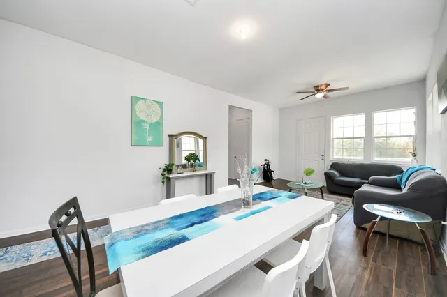 a kitchen with cabinets appliances and wooden floor