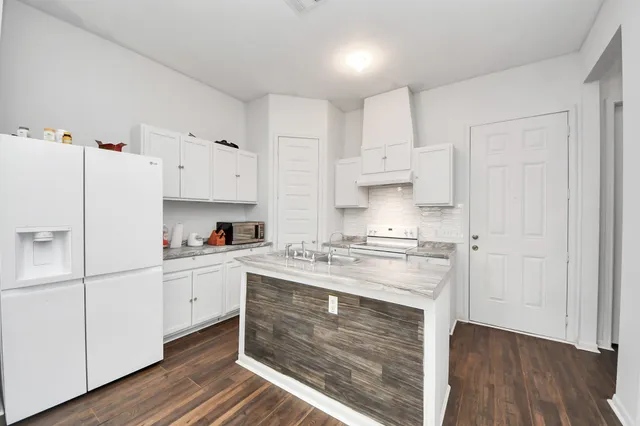 a kitchen with stainless steel appliances white cabinets and a sink