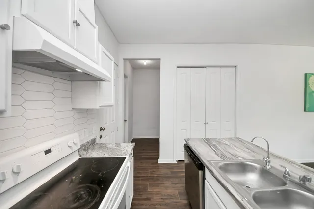 a kitchen with cabinets appliances and a sink