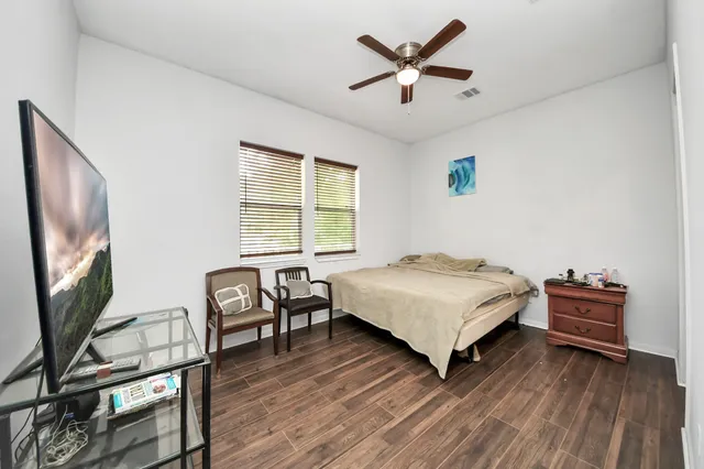 a bedroom with a bed and a ceiling fan