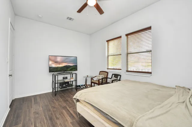 a bathroom with a granite countertop sink a mirror and a bathtub