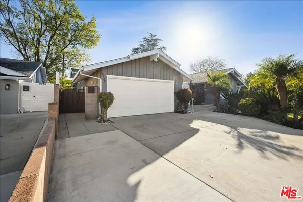 a view of a house with a yard and garage
