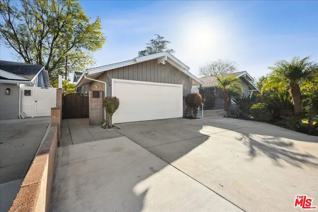 a view of a house with a yard and garage