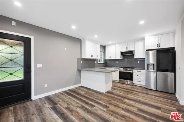 a kitchen with a refrigerator stove and oven