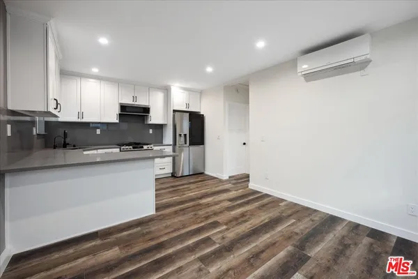 a large kitchen with kitchen island a sink stainless steel appliances and cabinets