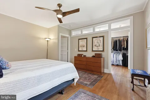 a large bedroom with a bed and a chandelier