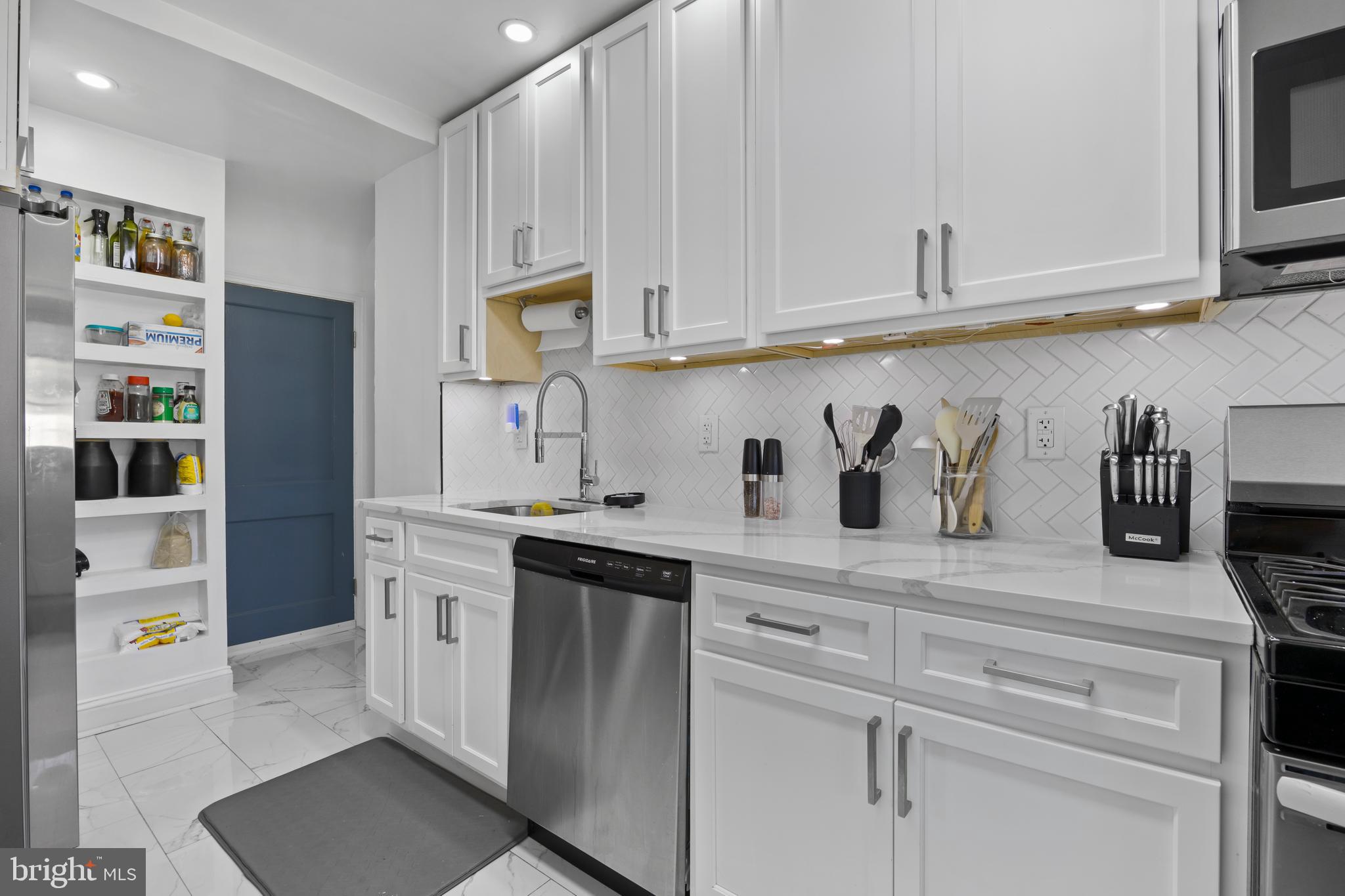 4511 Marble Hall Road Baltimore, MD 21239 - Photo 19 of 48 a kitchen with stainless steel appliances granite countertop white cabinets and a refrigerator