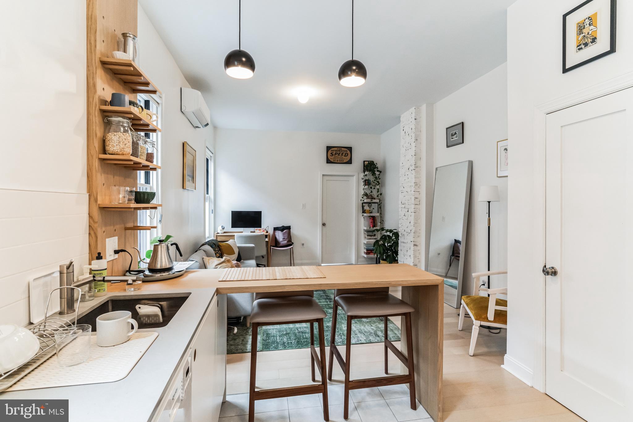 a kitchen with a table chairs sink and cabinets