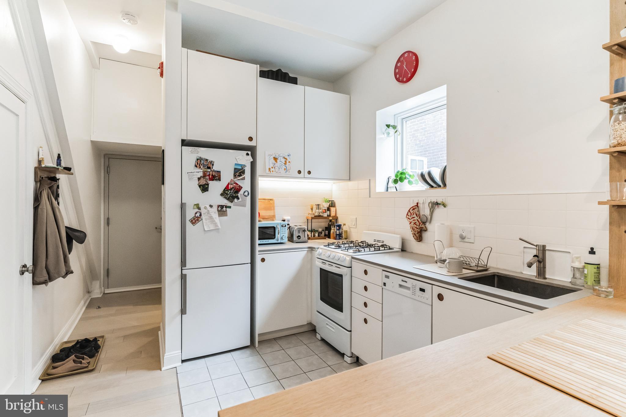 1108 Pine Street, Unit 3F Philadelphia, PA 19107 - Photo 5 of 8 a kitchen with stainless steel appliances a refrigerator sink and cabinets