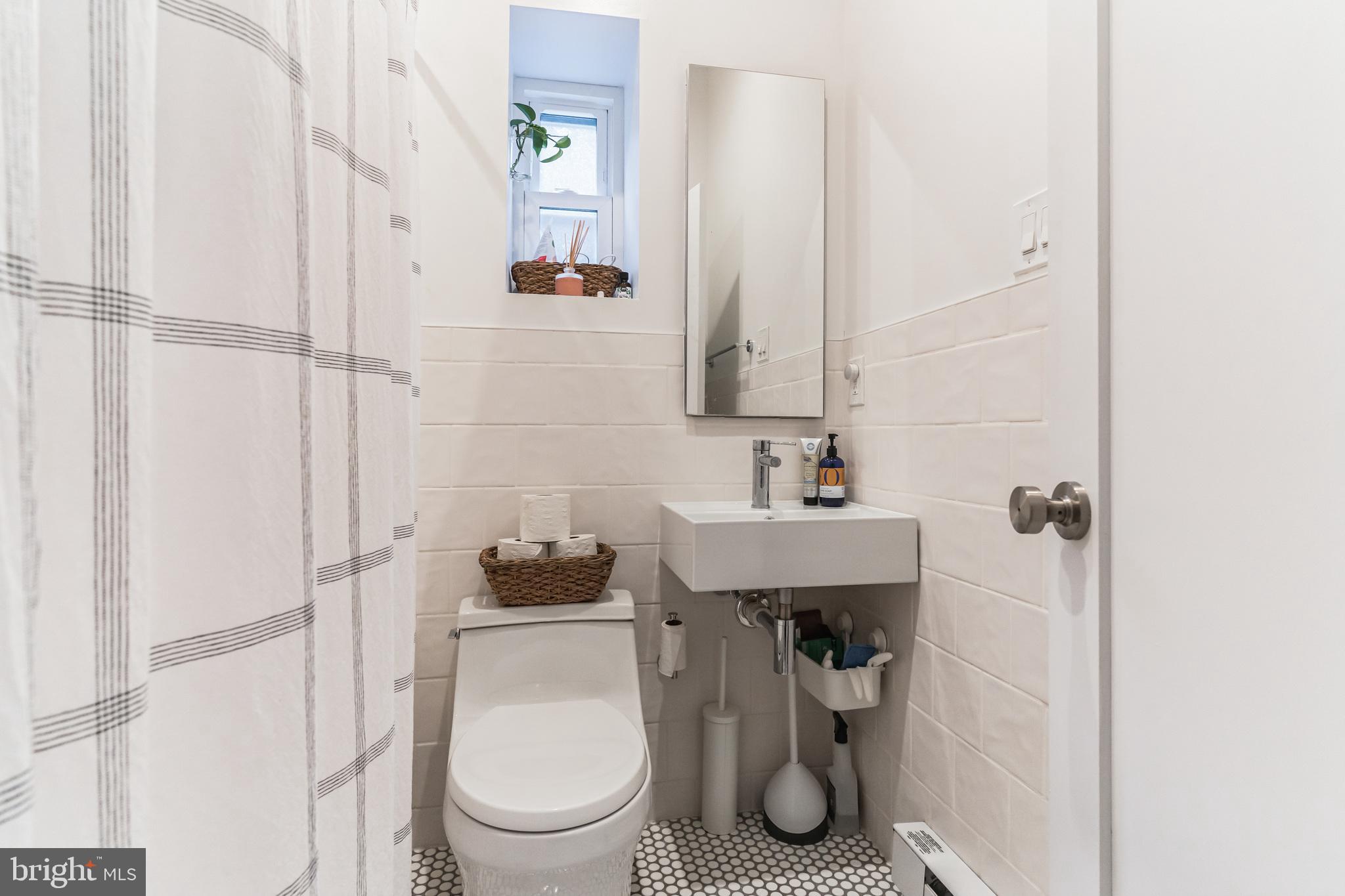 1108 Pine Street, Unit 3F Philadelphia, PA 19107 - Photo 8 of 8 a bathroom with a toilet a sink and shower