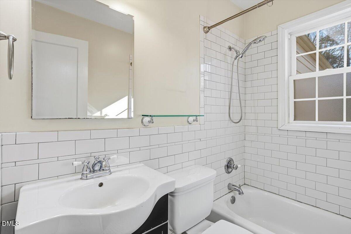 2106 Tudor Place Raleigh, NC 27610 - Photo 12 of 16 a bathroom with a sink and a bathtub