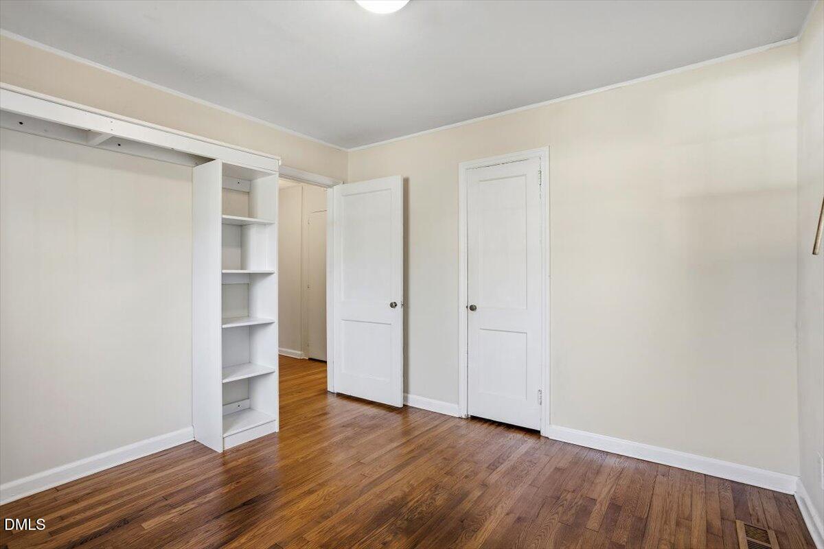 2106 Tudor Place Raleigh, NC 27610 - Photo 14 of 16 a view of empty room with wooden floor