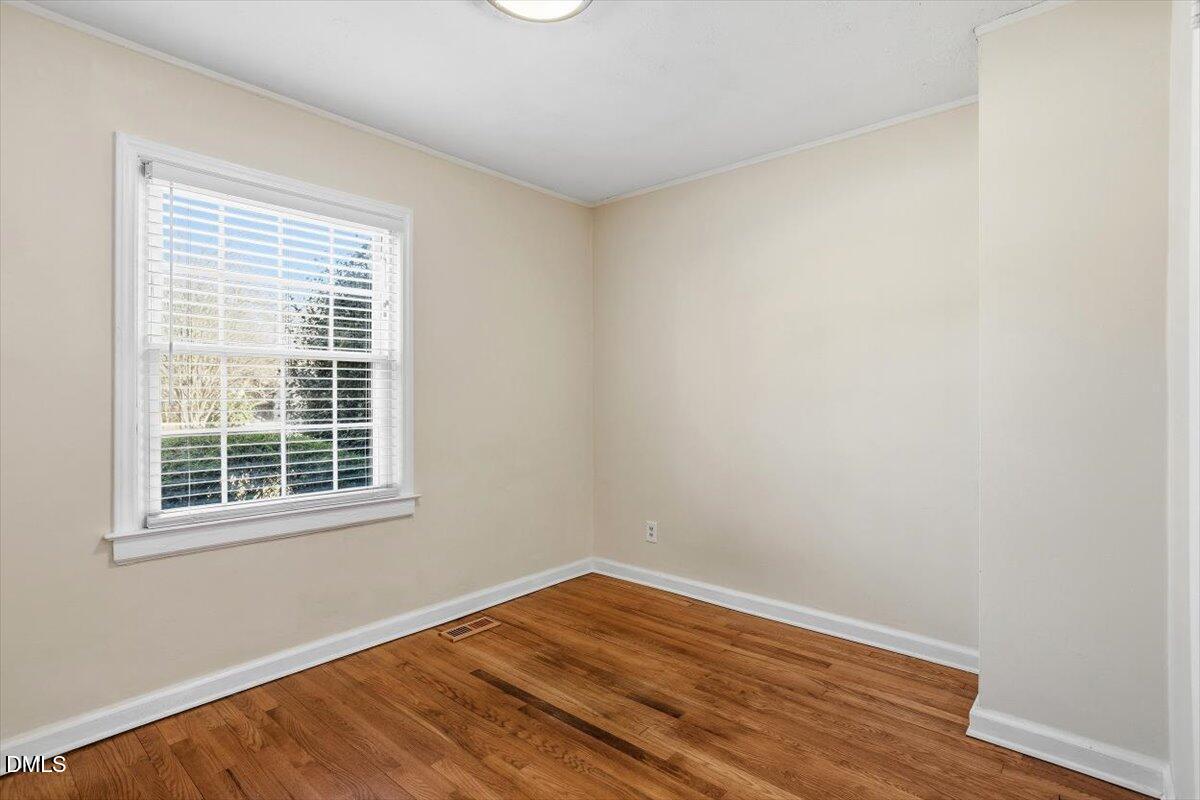 2106 Tudor Place Raleigh, NC 27610 - Photo 15 of 16 a view of empty room with wooden floor and fan