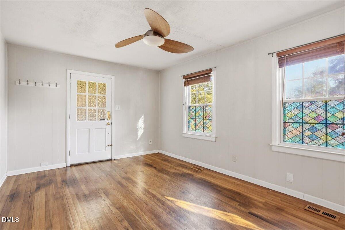 2106 Tudor Place Raleigh, NC 27610 - Photo 3 of 16 a view of empty room with wooden floor and fan