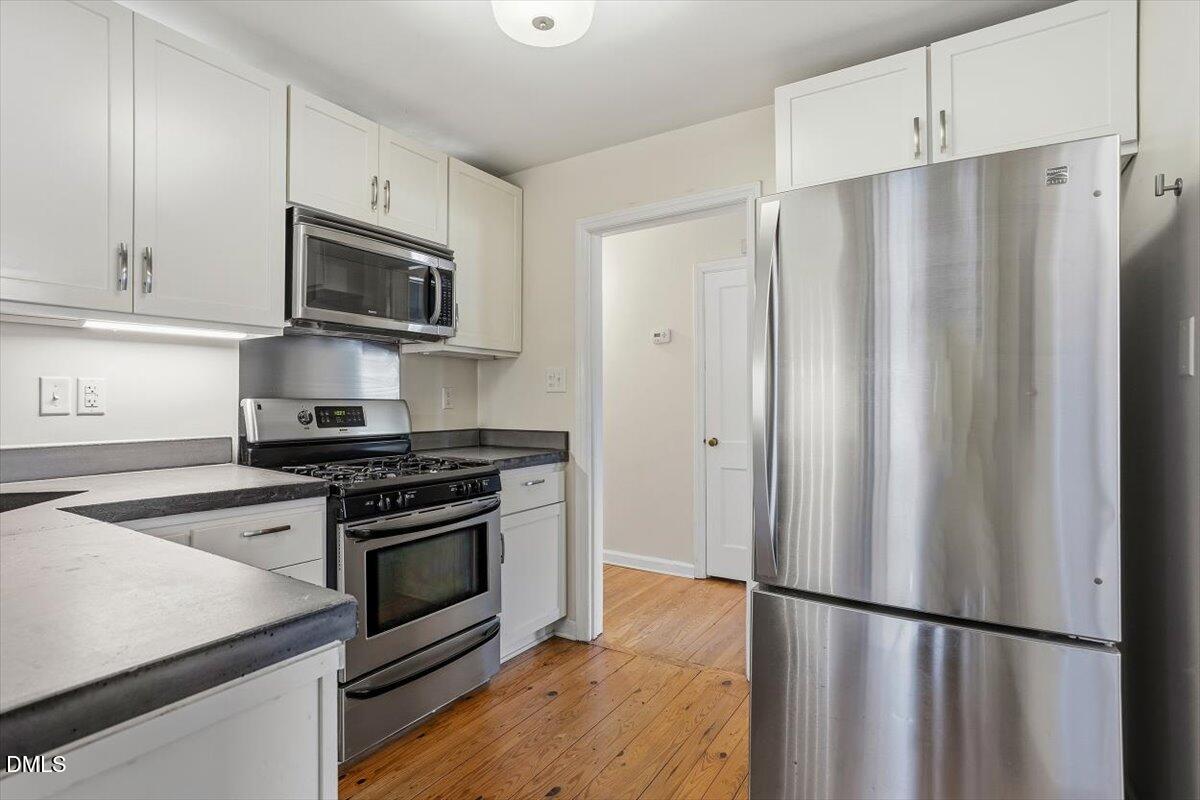 2106 Tudor Place Raleigh, NC 27610 - Photo 5 of 16 a kitchen with stainless steel appliances a refrigerator stove and microwave
