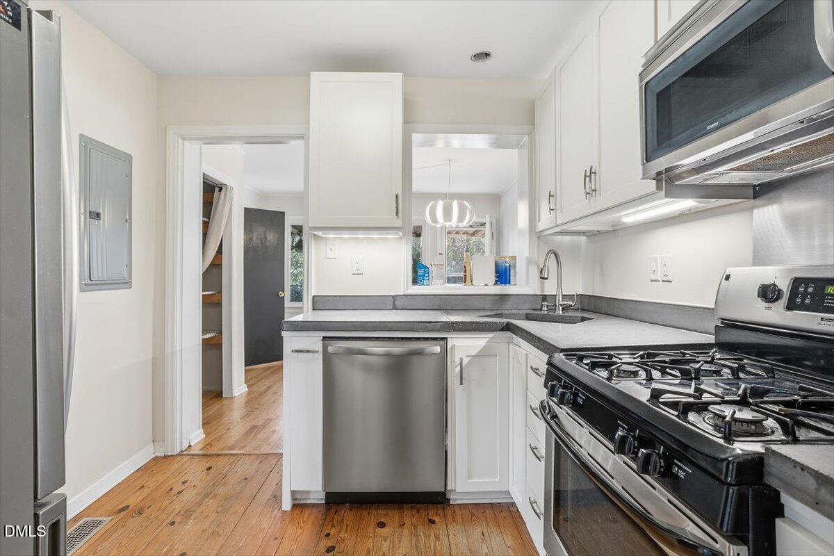 2106 Tudor Place Raleigh, NC 27610 - Photo 6 of 16 a kitchen with a stove and a refrigerator