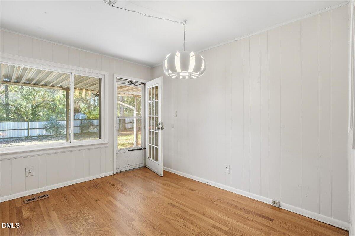 2106 Tudor Place Raleigh, NC 27610 - Photo 7 of 16 a view of empty room with wooden floor and fan