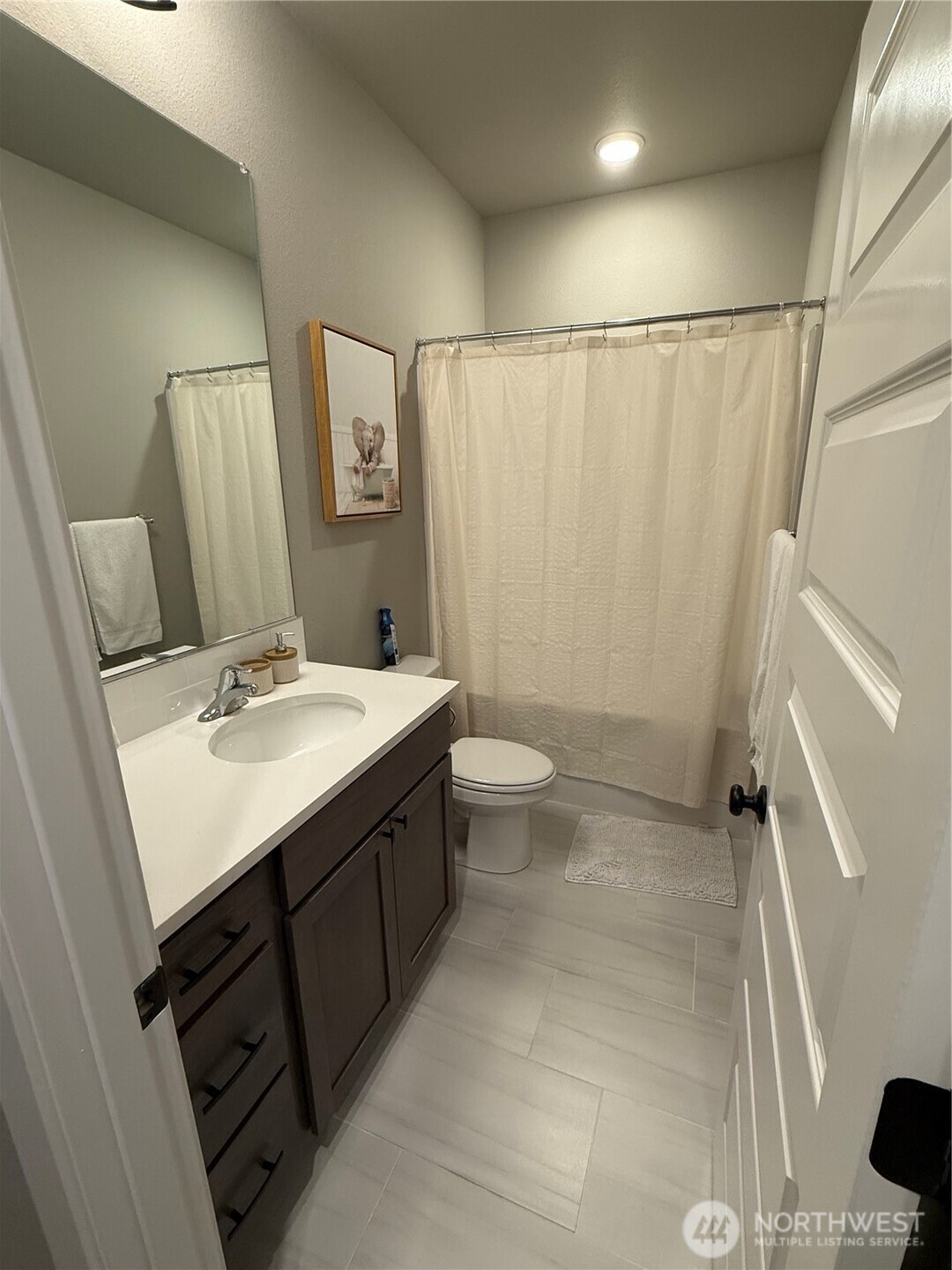 7013 South Hyton Street Cheney, WA 99004 - Photo 11 of 27 a bathroom with a sink a toilet a mirror and shower