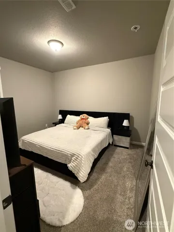a view of a hallway with wooden floor and a chandelier