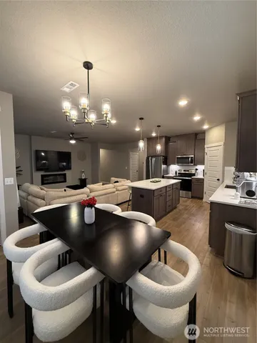 a living room with furniture and kitchen view