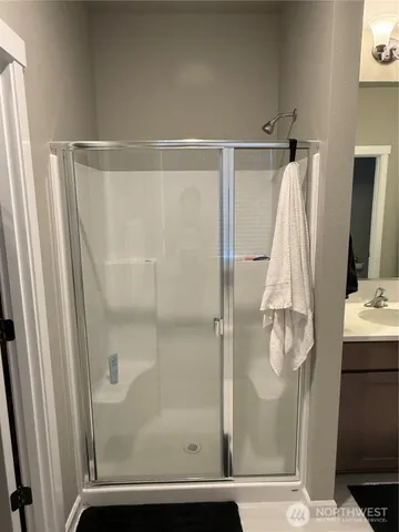 a bathroom with bathtub and next to a window