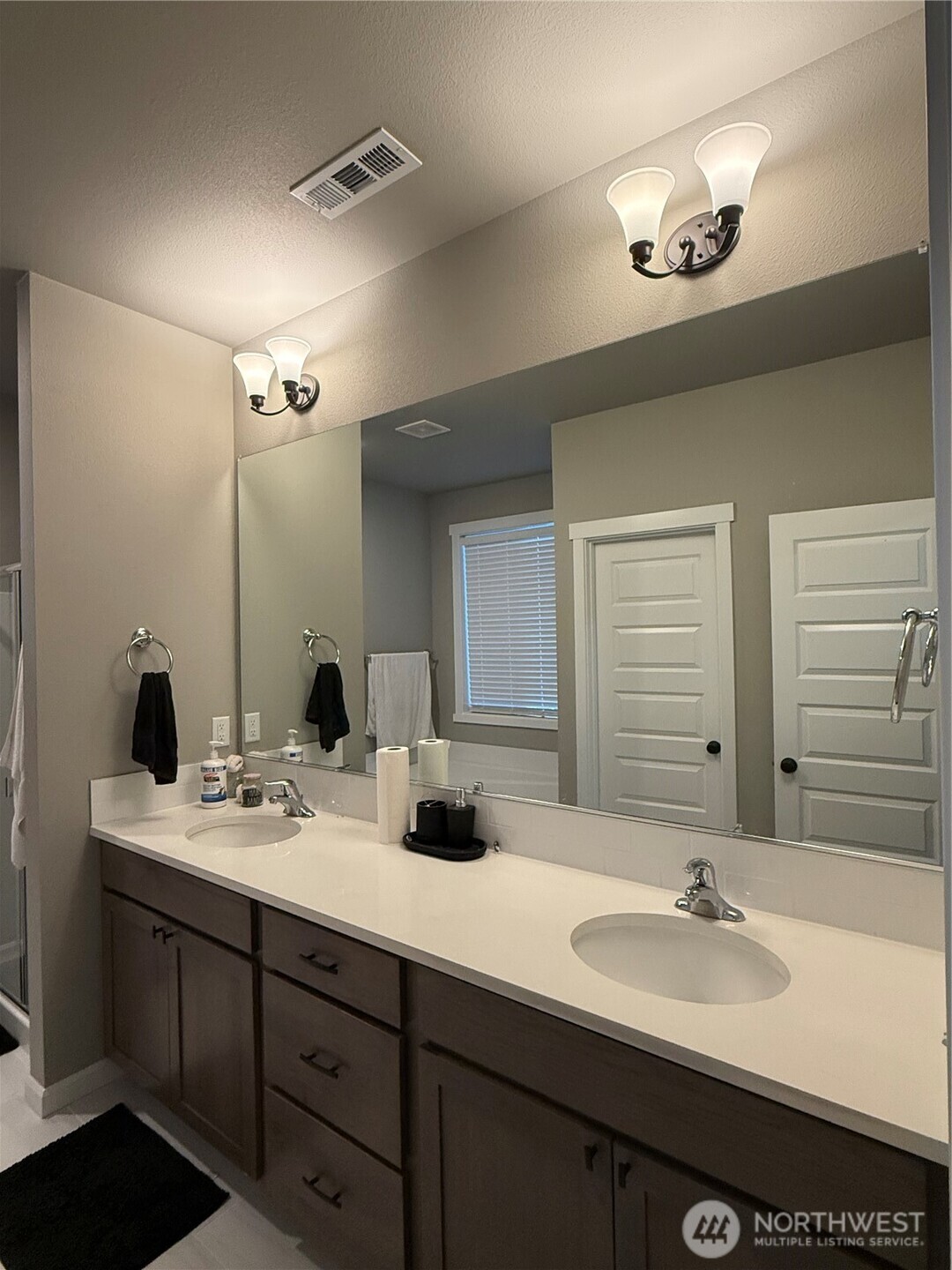 7013 South Hyton Street Cheney, WA 99004 - Photo 9 of 27 a bathroom with a double vanity sink and a mirror