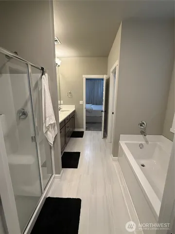 a bathroom with a sink a toilet a mirror and shower