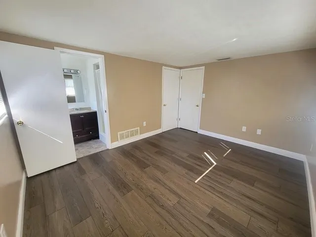 a view of room with window and wooden floor