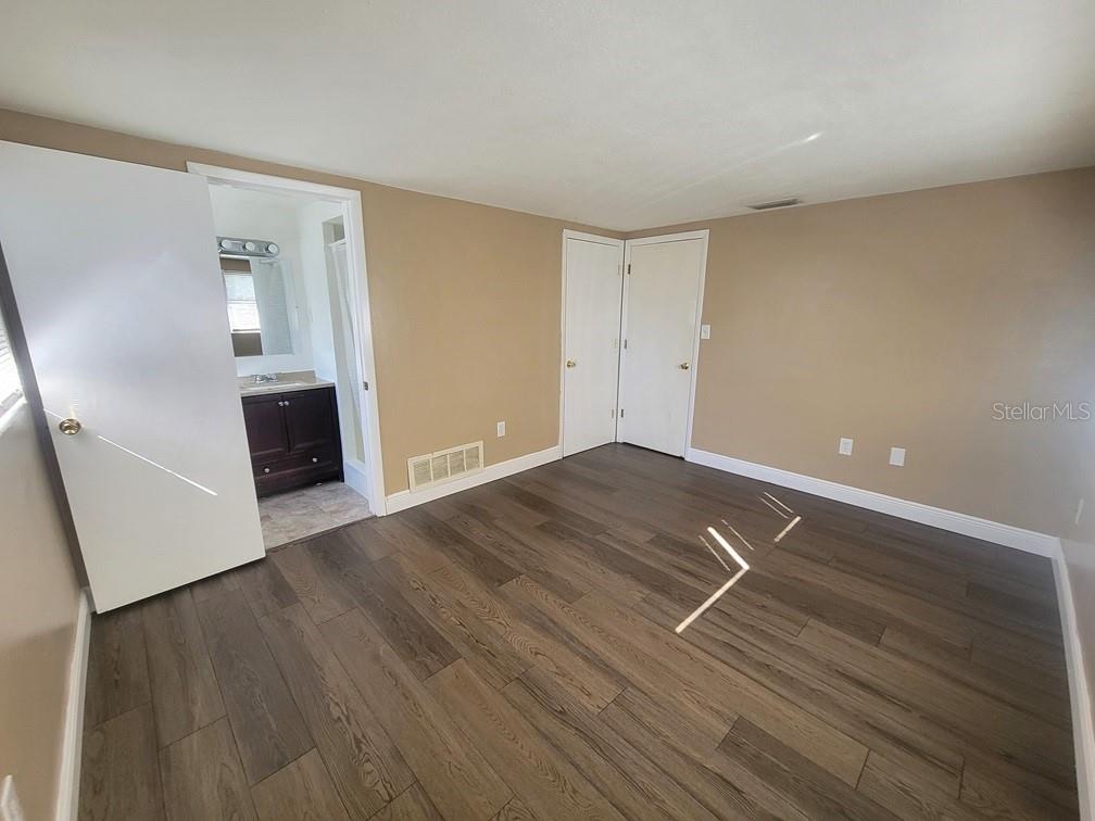 7922 Kelpie Drive Port Richey, FL 34668 - Photo 11 of 24 a view of room with window and wooden floor