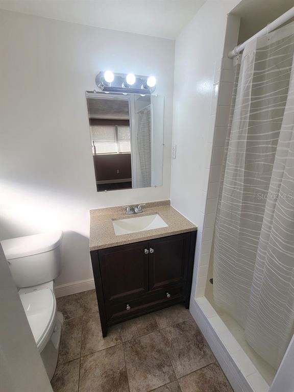 7922 Kelpie Drive Port Richey, FL 34668 - Photo 13 of 24 a bathroom with a sink a toilet and shower