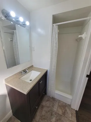 a bathroom with a sink vanity and a mirror