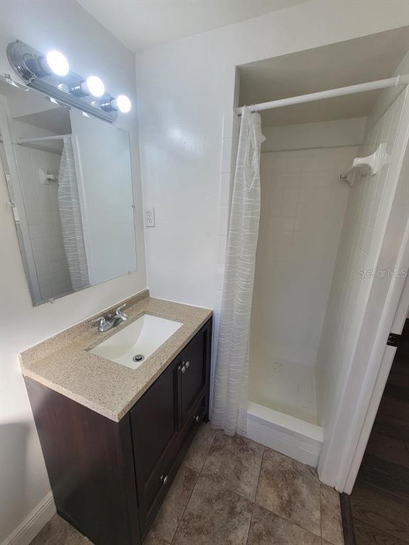 7922 Kelpie Drive Port Richey, FL 34668 - Photo 14 of 24 a bathroom with a sink vanity and a mirror