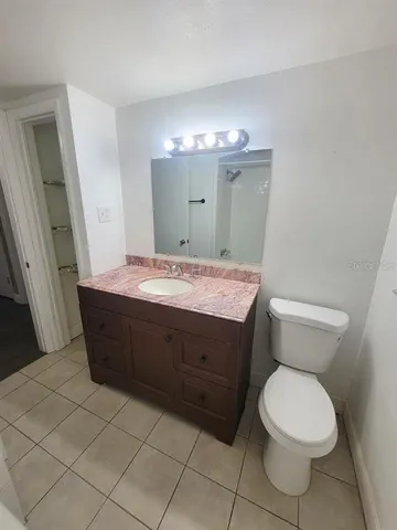 a bathroom with a toilet a sink and a mirror