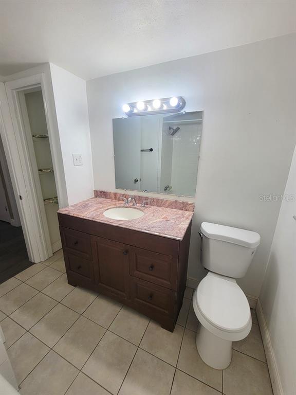 7922 Kelpie Drive Port Richey, FL 34668 - Photo 19 of 24 a bathroom with a toilet a sink and a mirror