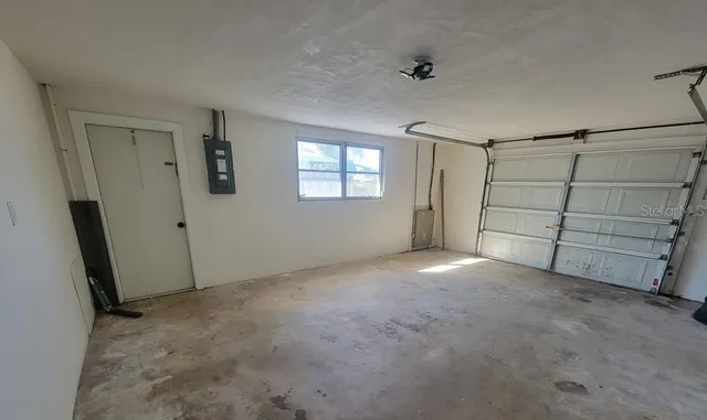 a view of an empty room with windows and closet