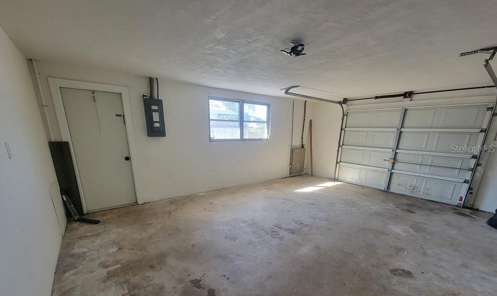 7922 Kelpie Drive Port Richey, FL 34668 - Photo 22 of 24 a view of an empty room with windows and closet