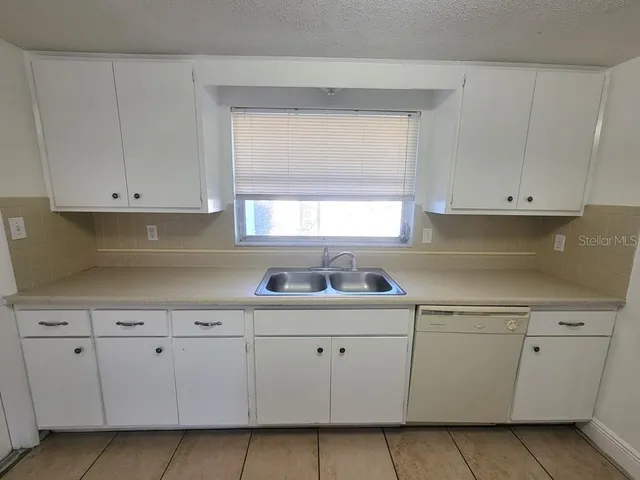 a kitchen with white cabinets