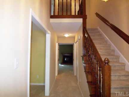 1505 Edgeside Court Raleigh, NC 27609 - Photo 2 of 10 a view of a hallway with wooden floor and staircase