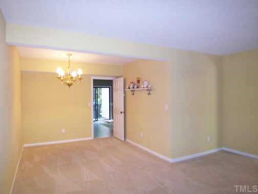 1505 Edgeside Court Raleigh, NC 27609 - Photo 4 of 10 a view of a livingroom with wooden floor and a ceiling fan