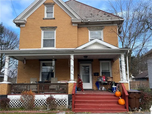 a view of a house with door and wooden fence