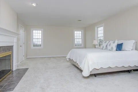 a spacious bedroom with a bed and a window