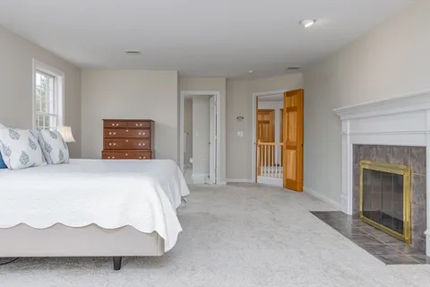 a spacious bedroom with a bed and a fireplace