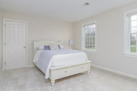 a spacious bedroom with a bed and a window