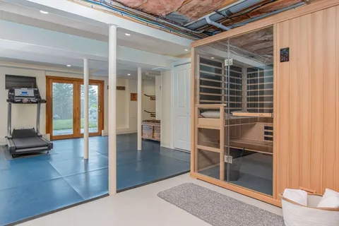 a view of a hallway with wooden floor and windows