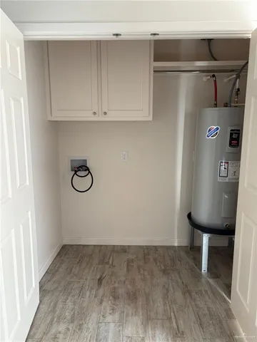 a view of storage and utility room with closet